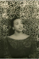 Portrait of Adele Addison in front of a patterned background. Written on verso: Photograph by Carl Van Vechten; 146 Central Park West; Cannot be reproduced without permission; April 8, 1955.