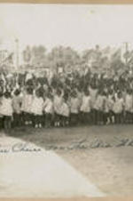 A large group of children wave flags. Written on recto: Three cheers for the red white and blue.