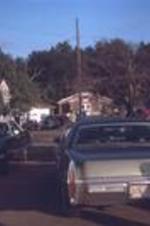 People and cars gathered outside of an unidentified church. Unknown location.