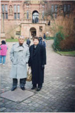 Joseph  and Evelyn Lowery standing outside a university in Frankfurt, Germany. Written on verso: Frankfurt, Germany - University Jan. 2000.