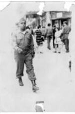 James K. Jordon (nephew of Robert E. Penn) in military uniform walks down the street in France.