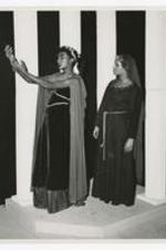 View of two women actors wearing costumes on stage