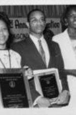 First and second place winners of the SCLC/W.O.M.E.N. Annual National Oratorical Contest are shown posing with their award plaques alongside an unidentified woman at the 29th Annual Southern Christian Leadership Conference Convention in Jacksonville, Florida.