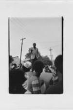 Andrew Young is shown standing on top of a car addressing a crowd of Local 1199 Union hospital workers.