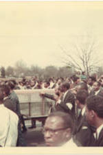 A group of people walk next to Martin Luther King Jr.'s casket.