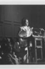 Coretta Scott King speaks at a podium.