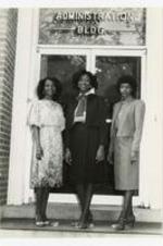 Group portrait of three women  in front of "Administation Bldg". Written on verso: "Miss Morris Brown and Court 1982; (LR Cassandra Hopkins, Myra Brown, Linda Fountain)".