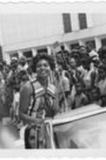 Billye Williams (now Billye Aaron), WSB's first African American woman to co-host a daily talk show, smiles from a parade car. Written on accompanying document: Billie Williams -Co-host on WSB Today Show.