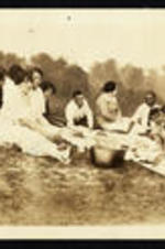 Virginia Lacy Jones and her family sit in the grass.