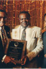 Southern Christian Leadership Conference (SCLC) President Joseph E. Lowery and Walter E. Fauntroy are shown presenting the SCLC Corporate Responsibility Award to John Cox at the 35th Annual SCLC Convention