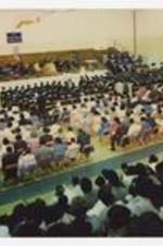 Indoor view of commencement ceremony in gymnasium.