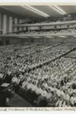 Indoor view of a full auditorium. Written on recto: 3rd National Conference of Methodist Men - Purdue University Lafayette, Ind..