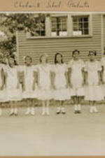 A group of young girls stand outside of the home. Written on recto: Chadwick School graduates.