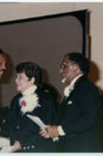 Reverend Jesse Jackson shakes hands with Evelyn G. Lowery as Joseph E. Lowery looks on during an event celebrating Lowery's 40th anniversary as a Methodist minister.