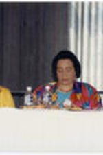 Coretta Scott King sits on the dais at the SCLC/W.O.M.E.N. Luncheon held as part of the proceedings of the 39th Annual Southern Christian Leadership Conference Convention in Detroit, Michigan. U.S. House Representative Cynthia McKinney is at left in the photo.