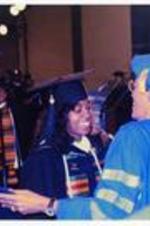 Written on verso: Commencement 1993; President Johnnetta B. Cole with student.