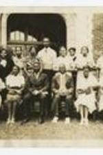 A group portrait of the Daily vacation Bible School Leadership Group on a lawn in front of a building.