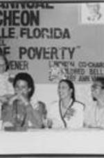 Rosa Parks, Carolyn Young, and other women are shown gathered at a SCLC/W.O.M.E.N. Annual Luncheon during the 29th Annual Southern Christian Leadership Conference Convention in Jacksonville, Florida.