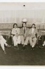Members of the Lampados Club pose in chairs. Written on verso: Lampados Club 1951, Left to Right, 1. Ruben Dawkins - class of '51, 2. Walter Cook, 3. Rufus Tucker - class of '51, 4. Curtis Ash - class of '53, Charles Jackson - class of '52.
