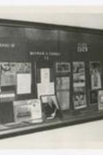 View of a display case "...aturing Life &amp; Works of Wayman A Carver, Class 1929" with photographs, posters and other memorabilia.