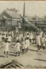 A large group of children play in the playground.