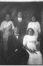 Group portrait of a family of two men and three women. Written on verso: Family photograph; Left to Right: seated 1. President J. W. E Bowen (Gammon) 2. Mrs. Bowen (Irene)  Left to Right, standing: 1. Sister Juanita (?) 2. Bishop J. W. E Bowen (son) 3. sister Portia (?).