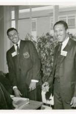 View of two men wearing name tags, "James Wilb..., Morehouse College (Junior)" and "Steven Brown, Morehouse College."