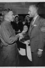 Harold Jackman shakes hands with unidentified man at the Stage Door Canteen.