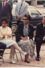 Andrew Young and others are shown sitting outside during an event that was part of the 35th Annual Southern Christian Leadership Conference Convention. Written on verso: SCLC/WOMEN