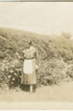 Elizabeth McDuffie walks through a garden. Written on verso: Hyde Park.