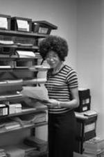 An unidentified woman smiles in a VEP office.