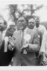 Southern Christian Leadership Conference (SCLC) President Joseph E. Lowery stands with his wife Evelyn G. Lowery (at right), N.Q. Reynolds, SCLC Board Chair Walter E. Fauntroy, and others during an outdoor event held as part of the proceedings of the 29th Annual SCLC Convention in Jacksonville, Florida.