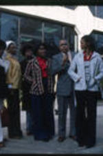 Unidentified male and female students speaking with Dr. Vivian Wilson Henderson.