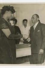 James P. Brawley and Mrs. Rice shake hands at an event.