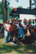 Evelyn G. Lowery and Ruby Shinhoster (at right, by tree) are shown posing for a photo with a group of children during a SCLC/W.O.M.E.N. Bridging the Gap: Girls to Women Mentoring Program event.