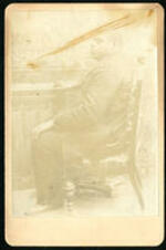 Thomas "Blind Tom" Bethune sitting by a piano.