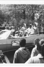 Miss Junior, Constance Smith, and her attendants ride on the back of a Morris Brown parade car.
