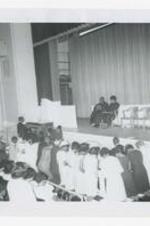 Written on verso: Clark College Commencement, Worship Service for parents + seniors, Left to right (on stage), 1. Dr. James P. Brawley, 2., ca. 1965.
