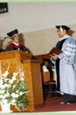 Faculty members stand on stage during 1979 graduation ceremony, including Grant Shockley.