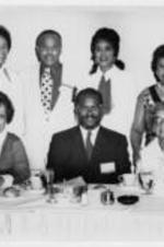 Virginia Lacy Jones with Edward A. Jones and Halle Brooks at ALA sponsored event. Written on verso: Virginia L. Jones (left), Edward A. Jones (2nd row; 2nd from left), Hallie Brooks (2nd row right).