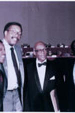 James P. Brawley at UNCF banquet. Written on verso: Taken at the UNCF Banquet during the UNCF tribute to Dr. Brawley. L to R: Clarence Cooper, Ronald Jackson, Dr. Brawley, and Carl Wise.