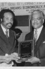 Southern Christian Leadership Conference (SCLC) Alabama State Chapter President John Nettles presents the "Legacy of the Dreamer" award in religion to Bishop Philip R. Cousin at the 5th Annual SCLC Alabama State Chapter Convention.