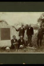 Group of unidentified men standing by Memorial of Edmund Ware, first president of Atlanta University.