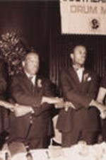 U.S. Representative John Lewis is shown holding hands with others during the proceedings of the 13th Annual Drum Major For Justice Awards. More details about the awards ceremony can be found on pages 48-51 of the June-July 1992 SCLC Magazine: http://hdl.handle.net/20.500.12322/auc.199:07049.