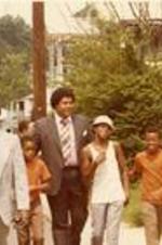 Maynard Jackson walks with group of unidentified men and boys.