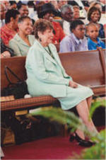 Evelyn G. Lowery is shown sitting in a church pew during a worship service at Providence Missionary Baptist Church in Atlanta, Georgia.