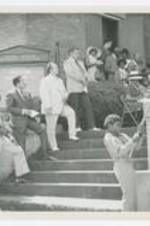 Exterior view of men and women on steps of Bethel AME Church with a young boyy holding a flag.