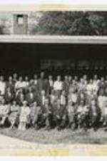 Outdoor group portrait of men and women in front of a building. Written on recto: Lexington Conference Annual Lay Retreat, Aug 30 - Sept 1963, Battle Ground.