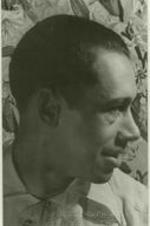 Portrait of Cab Calloway in front of a floral background.