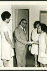 Dr. Vivian Wilson Henderson meets with five unidentified women.